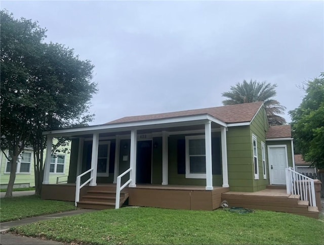 438 Indiana Ave, Corpus Christi, TX 78404 - back of house with roof with shingles, a porch, and a yard