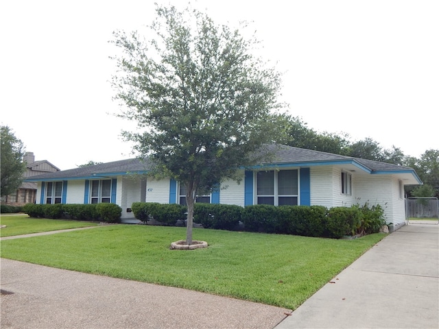 ranch-style home with a front lawn