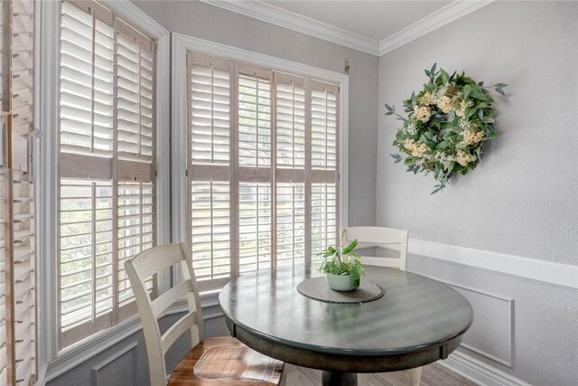 108 Lost Creek Dr, Portland, TX 78374 - dining area featuring healthy amount of natural light, ornamental molding, a textured wall, and a wainscoted wall