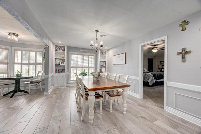 108 Lost Creek Dr, Portland, TX 78374 - dining area with light wood-type flooring, built in shelves, a chandelier, and ceiling fan