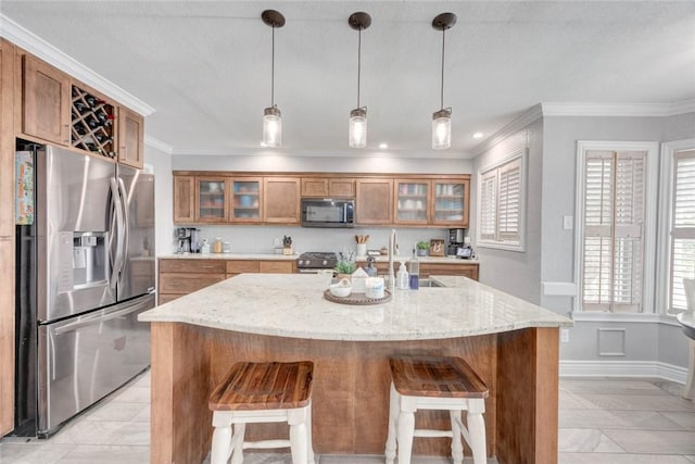 108 Lost Creek Dr, Portland, TX 78374 - kitchen with appliances with stainless steel finishes, brown cabinetry, a breakfast bar area, crown molding, and a sink