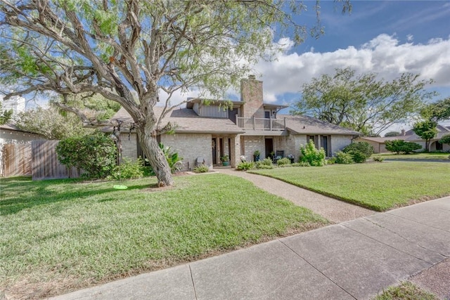 108 Lost Creek Dr, Portland, TX 78374 - mid-century modern home with a balcony, brick siding, and a chimney