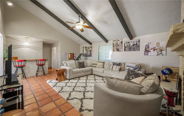 living room with lofted ceiling with beams, a textured ceiling, indoor bar, and ceiling fan