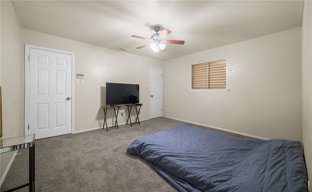 carpeted bedroom featuring a textured ceiling and ceiling fan