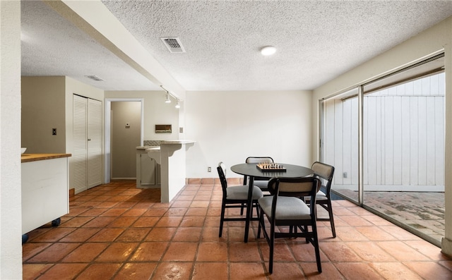 dining area with a textured ceiling