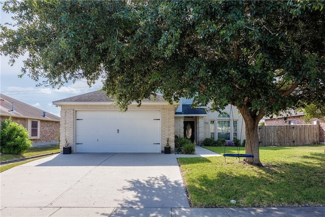 view of front of house featuring a garage and a front yard