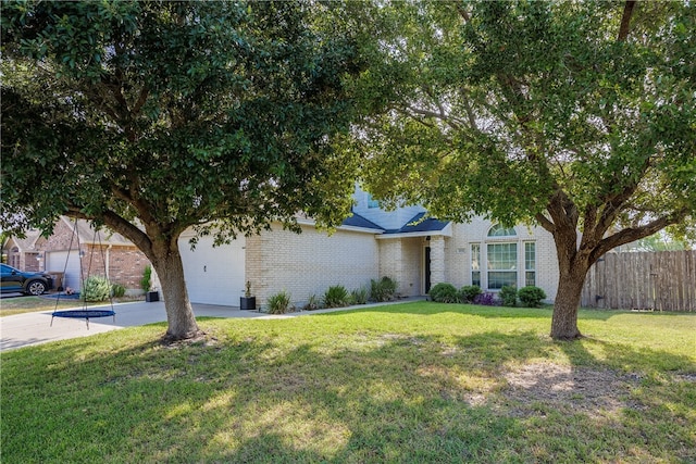 obstructed view of property with a garage and a front yard