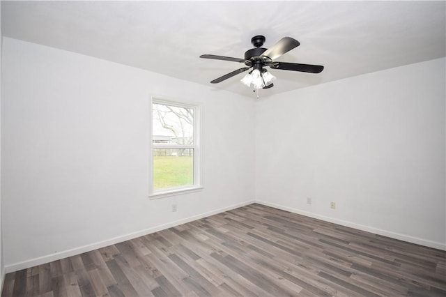 spare room with ceiling fan and dark hardwood / wood-style flooring