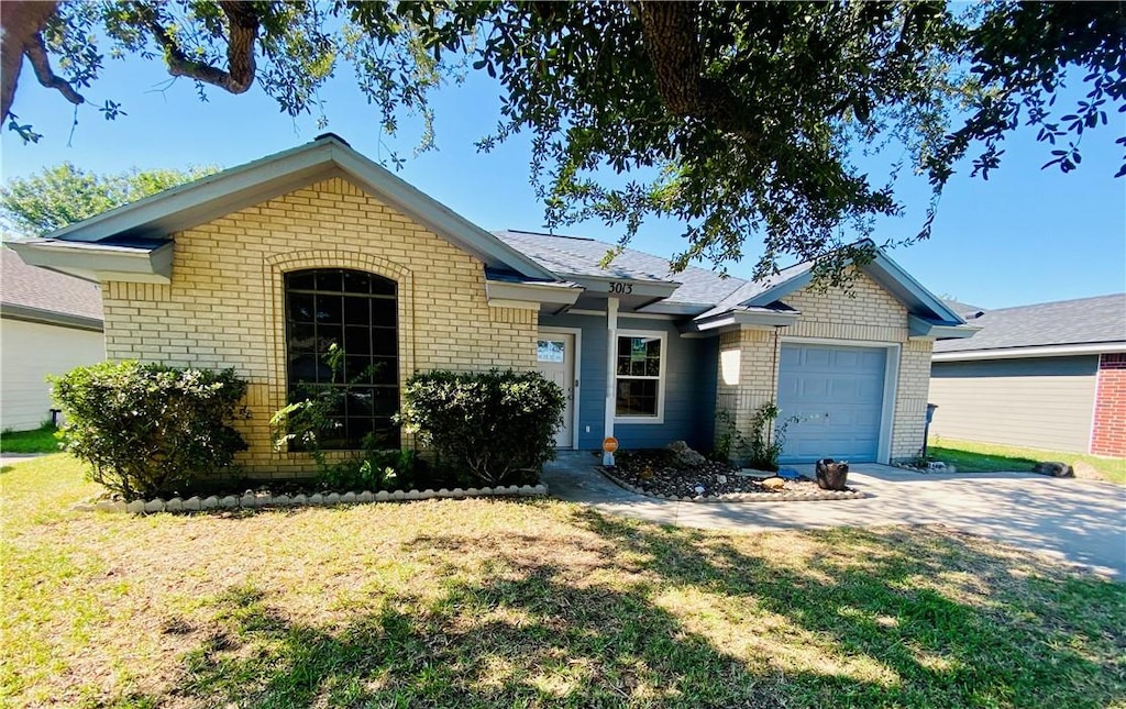 ranch-style home featuring a garage and a front lawn