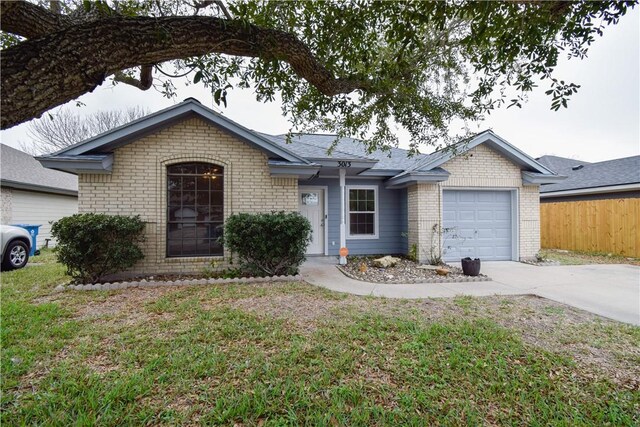 ranch-style home featuring a garage and a front lawn