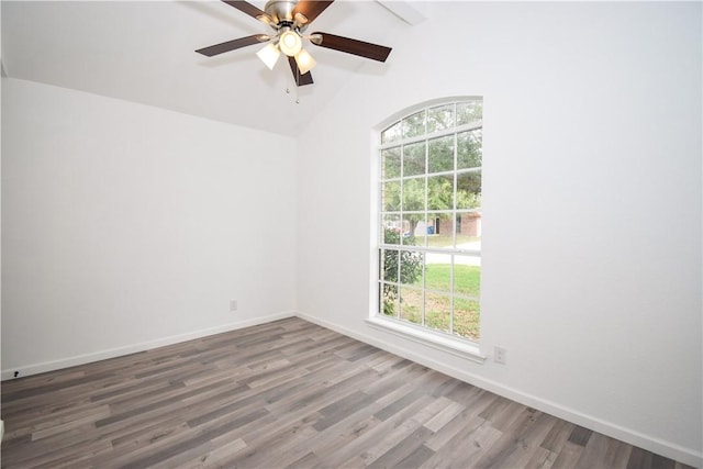 unfurnished room with ceiling fan, lofted ceiling, a healthy amount of sunlight, and dark hardwood / wood-style floors