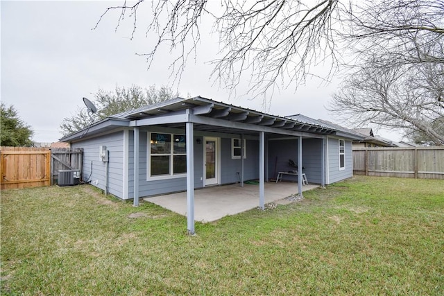 rear view of property featuring a patio, a yard, and central AC unit