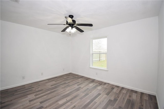 empty room with dark wood-type flooring and ceiling fan