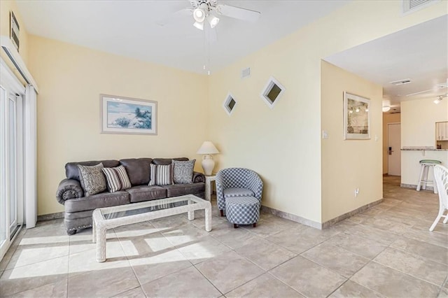 living room with visible vents, baseboards, and ceiling fan