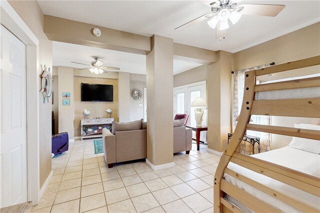 tiled living room with ceiling fan