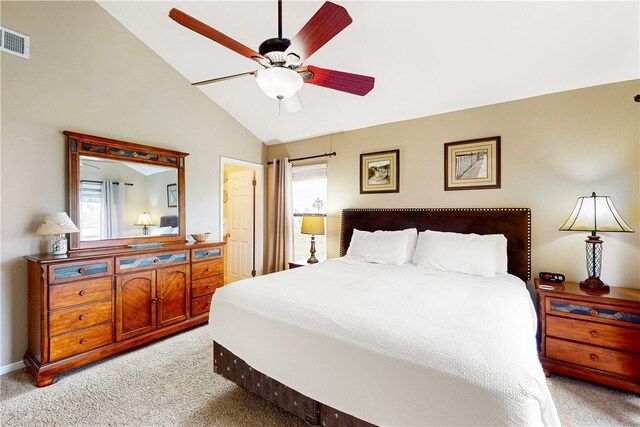 bedroom featuring light colored carpet, lofted ceiling, and ceiling fan