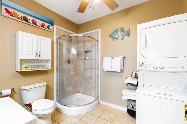 bathroom with stacked washer and dryer, tile patterned flooring, toilet, and walk in shower