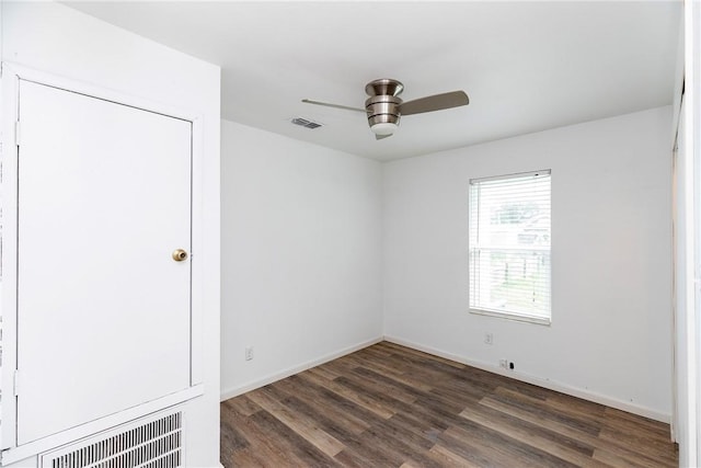 unfurnished bedroom featuring a ceiling fan, baseboards, visible vents, and wood finished floors