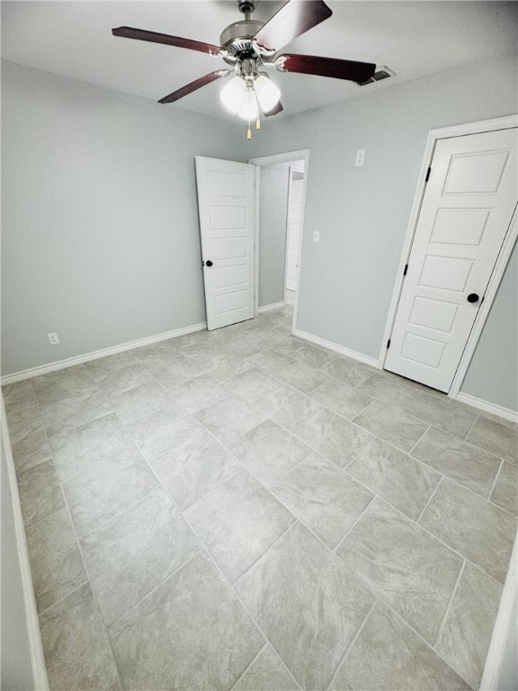 unfurnished bedroom featuring ceiling fan