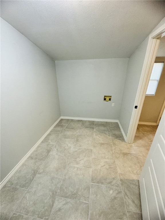 laundry area featuring washer hookup and a textured ceiling