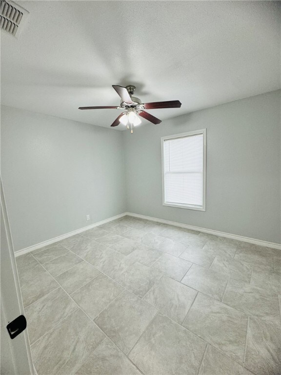 spare room with ceiling fan