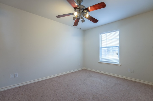 unfurnished room featuring ceiling fan and light colored carpet