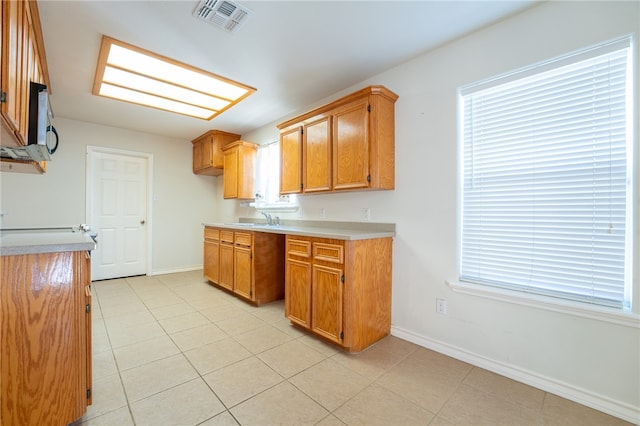 kitchen featuring light tile patterned flooring and sink