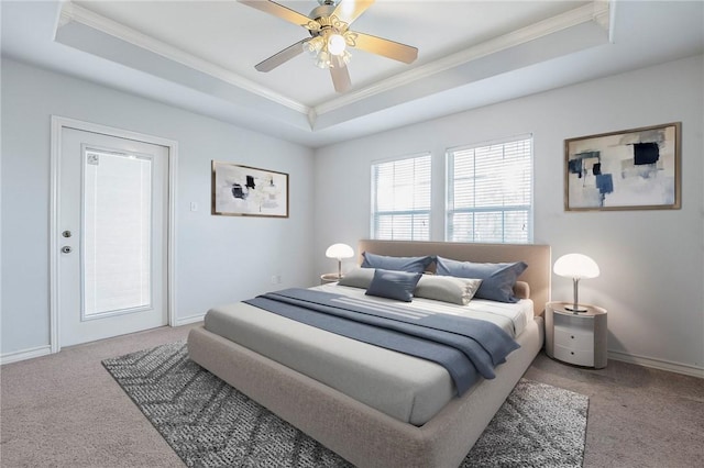 bedroom featuring ceiling fan, a raised ceiling, and light carpet