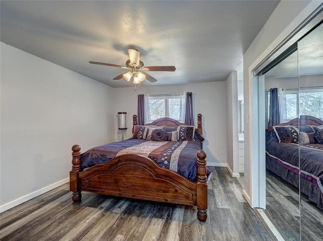 bedroom with dark hardwood / wood-style flooring and ceiling fan