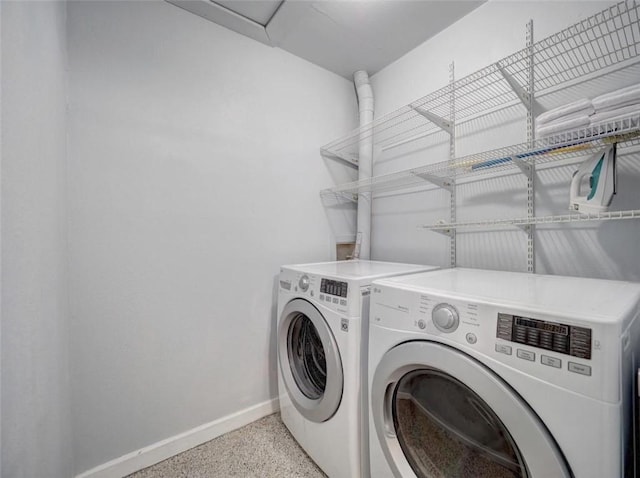 1011 Ennis Joslin Unit 224, Corpus Christi, TX 78412 - laundry room featuring baseboards and washing machine and clothes dryer