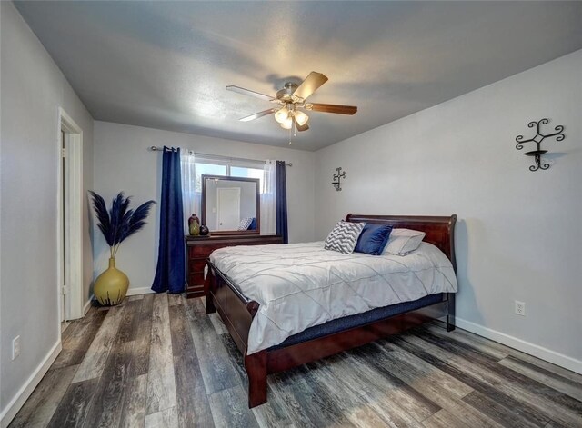 bedroom featuring dark wood-type flooring and ceiling fan