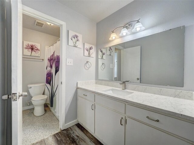 bathroom featuring hardwood / wood-style floors, vanity, and toilet