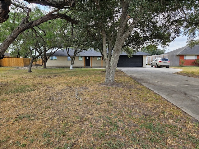 single story home with a garage and a front lawn