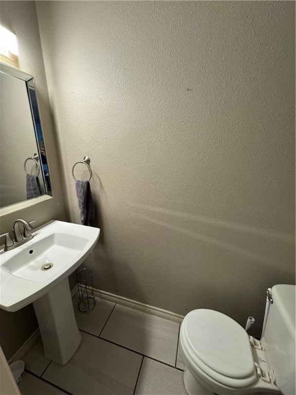 bathroom with tile patterned floors and toilet