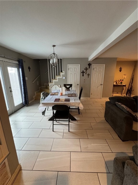 dining room featuring french doors and a chandelier