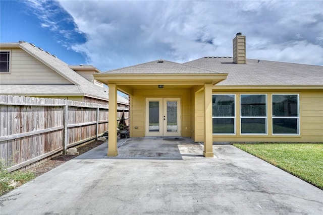 7505 Long S Dr, Corpus Christi, TX 78414 - back of property featuring french doors, fence, a chimney, and a patio