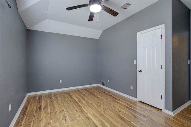 unfurnished room featuring vaulted ceiling, light hardwood / wood-style floors, and ceiling fan