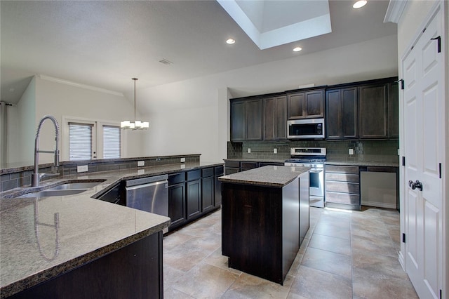 kitchen featuring pendant lighting, sink, appliances with stainless steel finishes, dark brown cabinets, and a center island