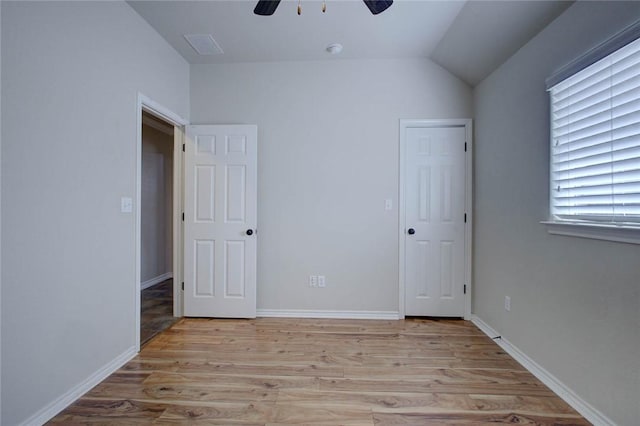 7505 Long S Dr, Corpus Christi, TX 78414 - unfurnished bedroom featuring light wood-style flooring, lofted ceiling, ceiling fan, and baseboards