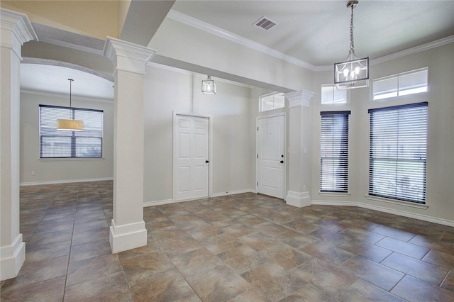 foyer featuring crown molding and decorative columns