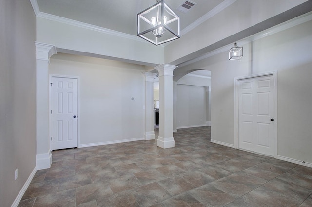 empty room featuring a notable chandelier, ornamental molding, and decorative columns