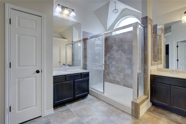 bathroom with vaulted ceiling, an enclosed shower, and vanity