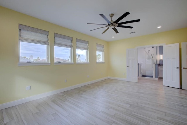 empty room featuring recessed lighting, baseboards, and light wood finished floors