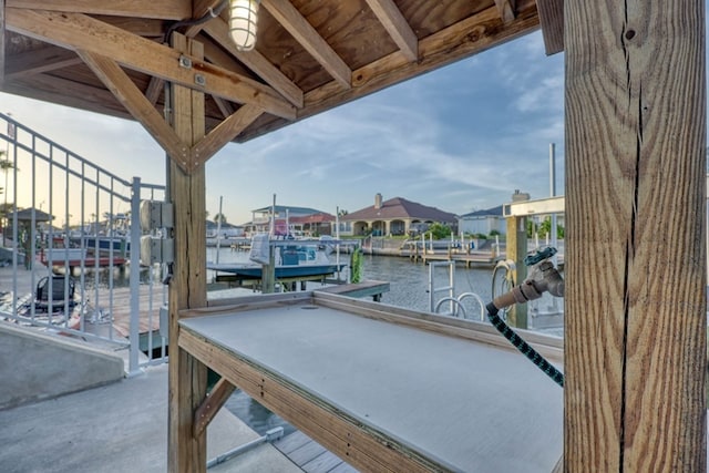 dock area with a water view and boat lift