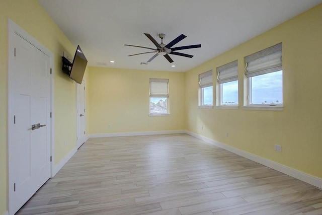 empty room with recessed lighting, baseboards, ceiling fan, and light wood finished floors