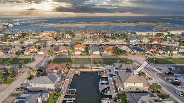 drone / aerial view featuring a water view and a residential view