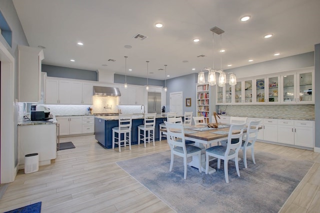 dining space featuring recessed lighting, visible vents, and light wood finished floors