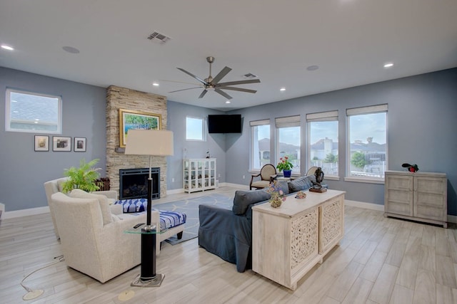 102 Angelfish Ct, Aransas Pass, TX 78336 - living area featuring a ceiling fan, baseboards, a stone fireplace, recessed lighting, and light wood finished floors