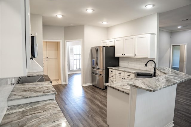 100 Lone Oak St, Portland, TX 78374 - kitchen featuring a sink, a peninsula, stainless steel fridge, light stone counters, and dark wood-type flooring