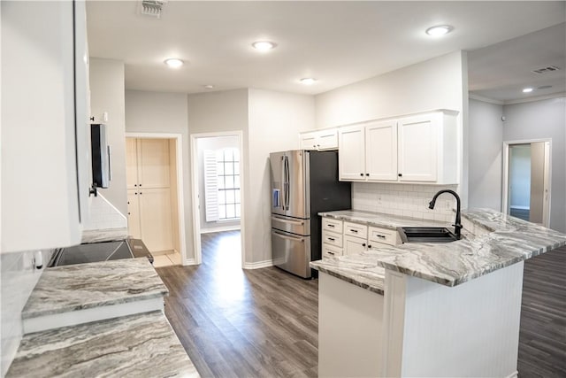 100 Lone Oak St, Portland, TX 78374 - kitchen featuring a sink, a peninsula, stainless steel refrigerator with ice dispenser, dark wood-style flooring, and light stone countertops